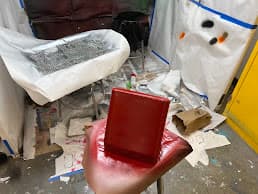 Spray-painting the red enclosure